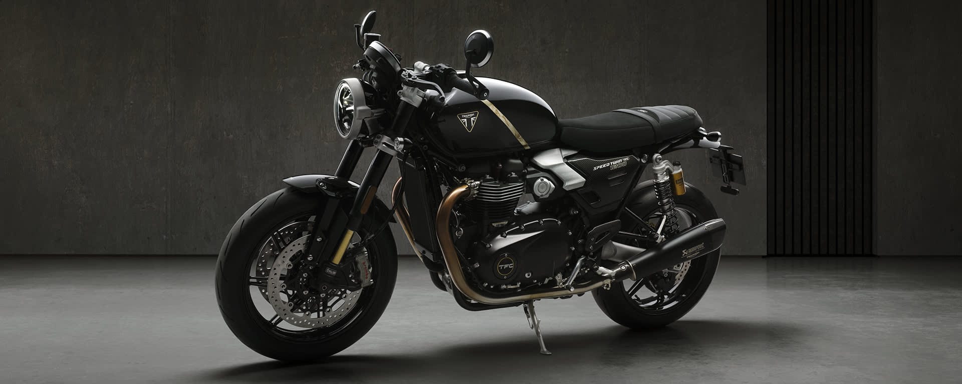 Triumph Speed Twin 1200 TFC, rear three-quarter view showing Akrapovic exhaust