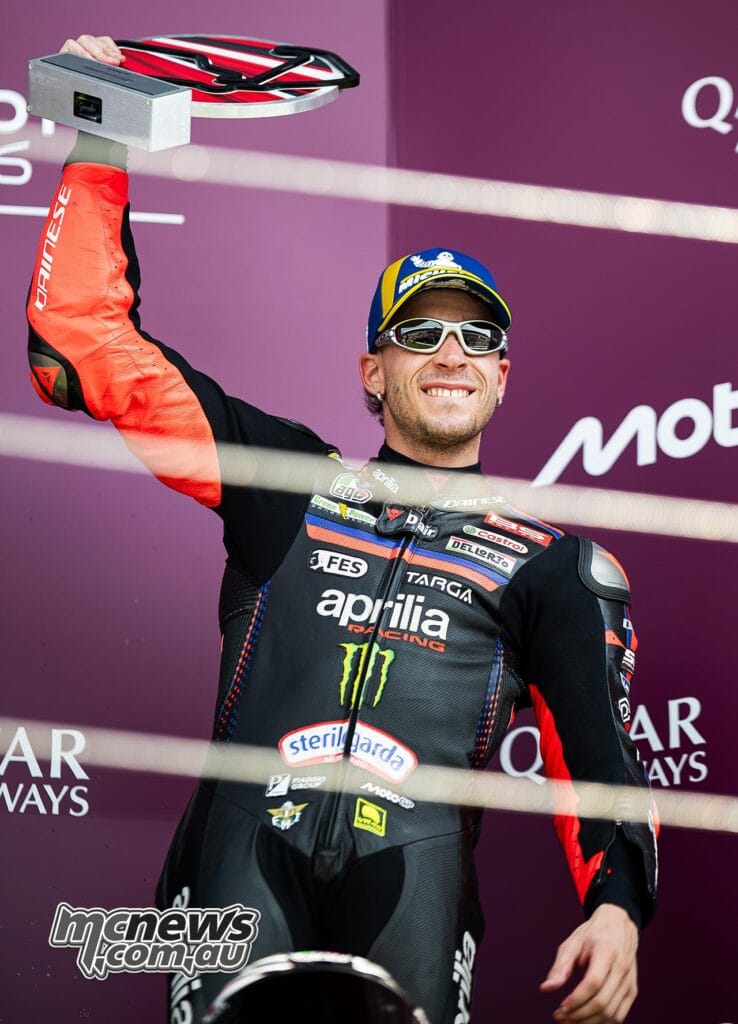 Marco Bezzecchi on the podium with his third-place trophy at the 2026 British MotoGP
