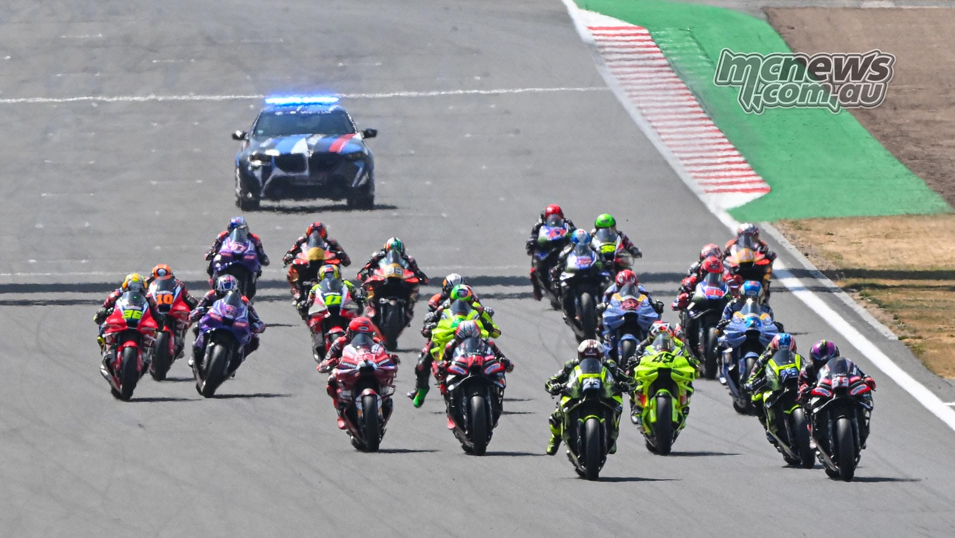 MotoGP grid at the start of the 2026 British Grand Prix at Silverstone, wide shot from the grandstand
