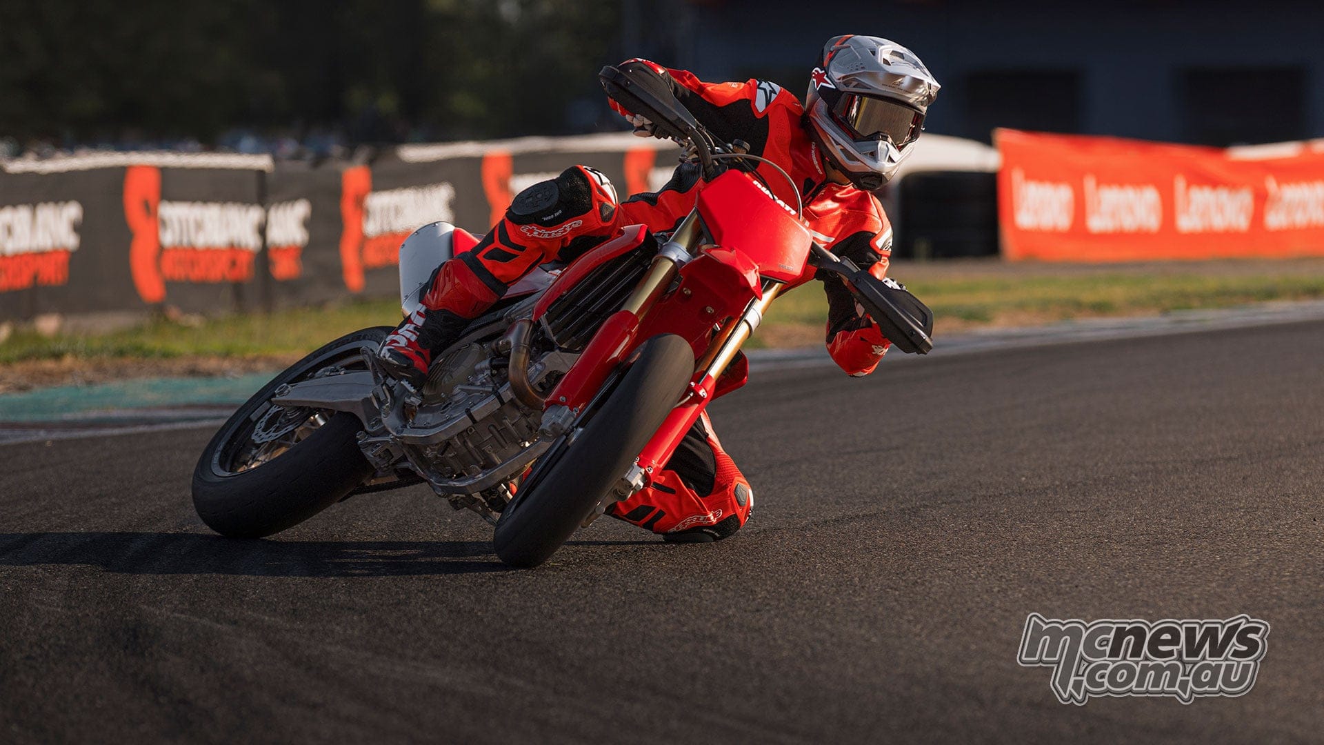 2026 Ducati Desmo450 SM in red bodywork, front three-quarter studio shot on slick tyres