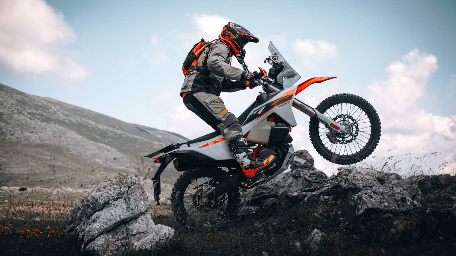 2027 KTM 690 Rally, front three-quarter view, in rally-raid bodywork with windscreen