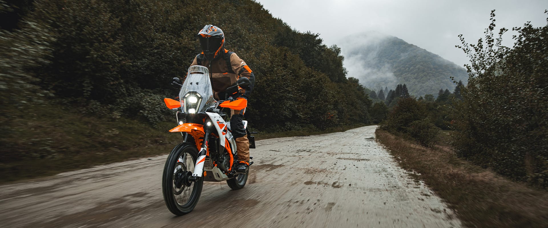 2026 KTM 390 Adventure R in white, riding off-road on a gravel track