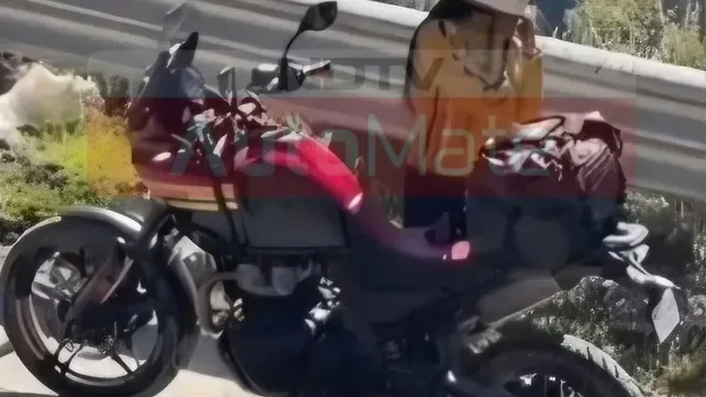 Royal Enfield Himalayan 750 prototype in red and gold colourway with alloy wheels, parked outdoors without camouflage