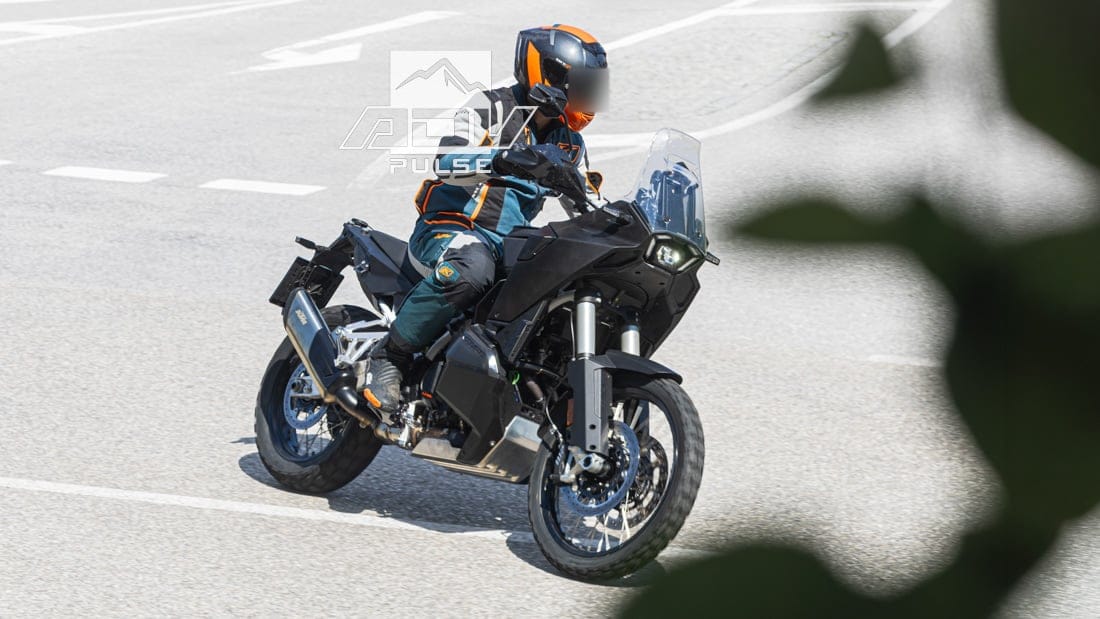 Camouflaged KTM 990 Adventure prototype, front three-quarter, showing dual fuel tank fillers