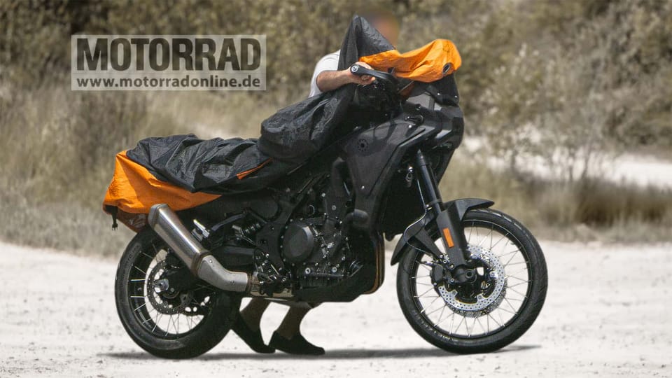 Camouflaged BMW midsize GS adventure prototype, front three-quarter, with X-shaped LED headlight and no front beak fitted yet