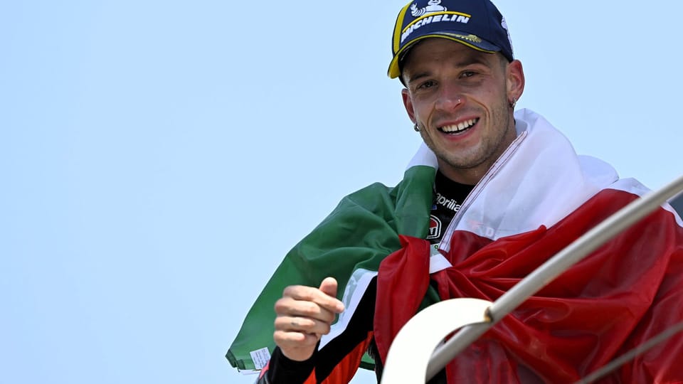 Marco Bezzecchi in Aprilia Racing leathers in the MotoGP paddock at Mugello, 2026 season