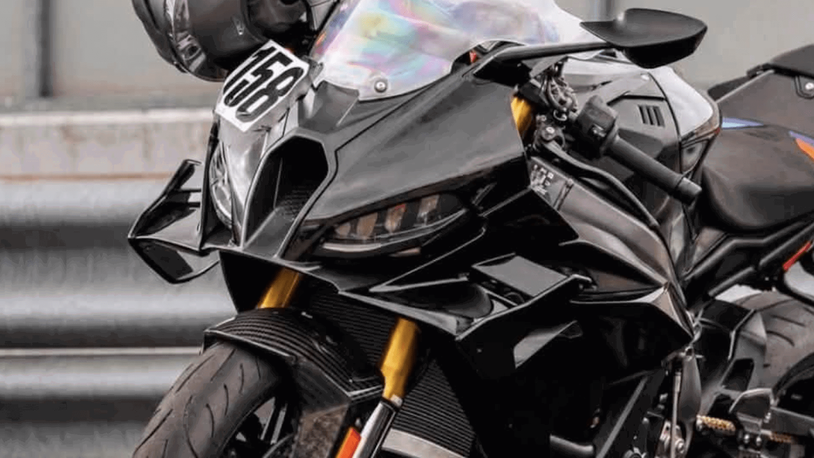 Camouflaged next-generation BMW S1000RR prototype leaned over during track testing at the Nurburgring