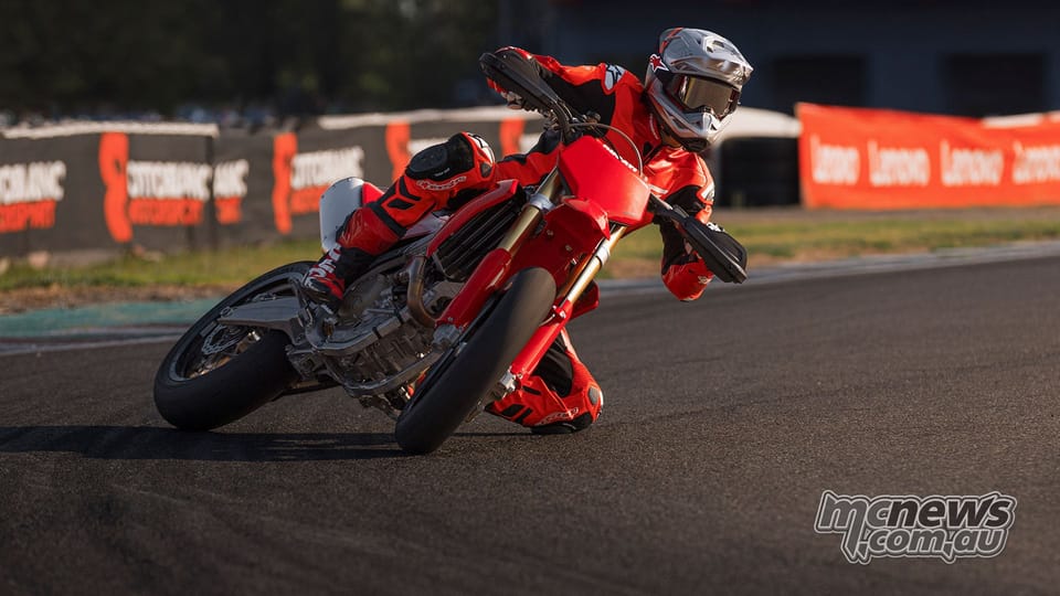 2026 Ducati Desmo450 SM in red bodywork, front three-quarter studio shot on slick tyres
