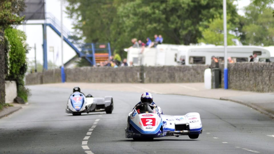 Isle of Man TT sidecar outfits racing on the Mountain Course
