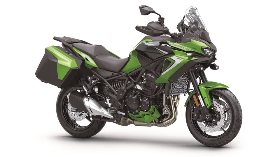 2027 Kawasaki Versys 900 in green, front three-quarter studio shot