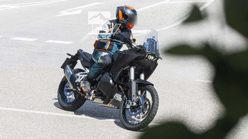 Camouflaged KTM 990 Adventure prototype, front three-quarter, showing dual fuel tank fillers